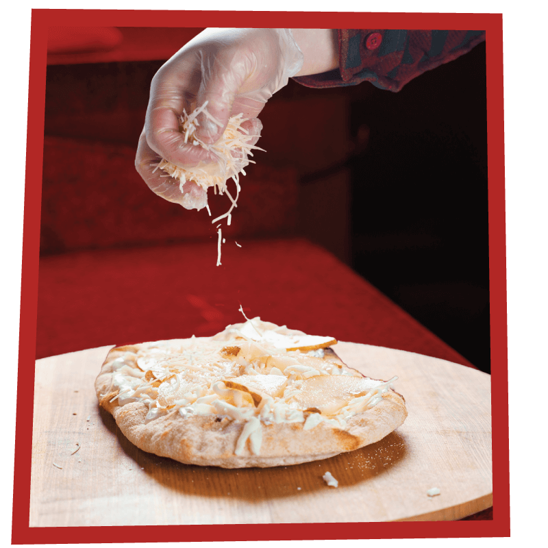 Making an EPICO Pinsa Romana pizza with a sprinkle of cheese